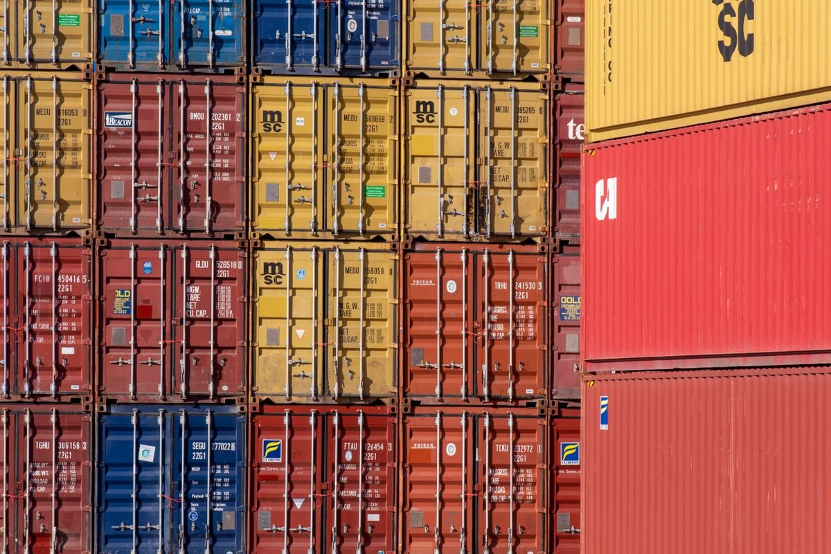 Shipping containers loaded for manufacturing and export services from India at a port